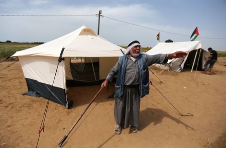 A Palestinian man gestures outside a tent near the border with Israel, in the southern Gaza Strip March 28, 2018. REUTERS/Ibraheem Abu Mustafa