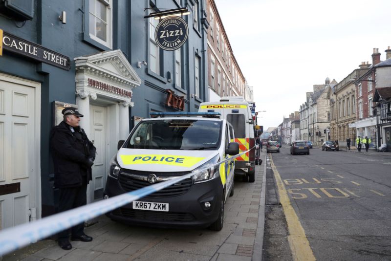A policeman stands outside the Zizzi restaurant in Salisbury, England Wednesday, March 7, 2018 near to where former Russian double agent Sergei Skripal was found critically ill. Britain's counterterrorism police took over an investigation Tuesday into the mysterious collapse of a former spy and his daughter, now fighting for their lives. The government pledged a 