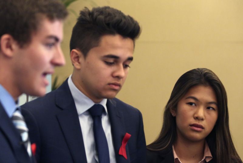 Parkland High School students Lewis Mizen, left, Kevin Trejos, center, and Suzanna Barna, right, speak to The Associated Press in Dubai, United Arab Emirates, Saturday, March 17, 2018. Student survivors of a Florida high school shooting took their message calling for greater gun safety measures abroad for the first time on Saturday, sharing with educational professionals from around the world their frightening experience. (AP Photo/Jon Gambrell)