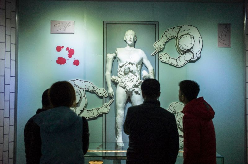Visitors look at a scene of human experiments at the Unit 731 museum in Harbin in northeast China in 2015