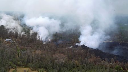 Molten rock flows and burst to the surface, threatening homes in a rural area in this still image from an aerial video taken from a Hawaii Army National Guard a week after the eruption of the Kilauea volcano, in Pahoa, Hawaii, U.S., May 10, 2018. Courtesy Andrew Jackson/Hawaii DoD/Handout via REUTERS