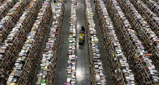 Image: Worker gathers items for delivery at Amazon's distribution center in Phoenix