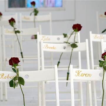 Image: Roses are placed on chairs for the victims of last week's shooting at the First Baptist Church