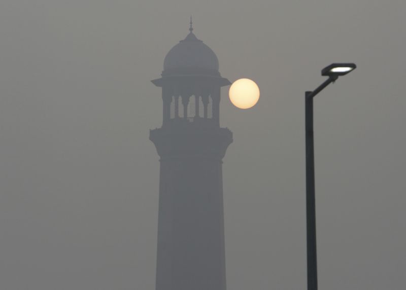 The sun raises next to the minaret of the historical Badshahi Mosque while smog envelopes the area in Lahore, Pakistan, Sunday, Nov. 5, 2017. Smog has enveloped much of Pakistan and neighboring India, causing highway accidents and respiratory problems, and forcing many residents to stay home, officials said. (AP Photo/K.M. Chaudary)