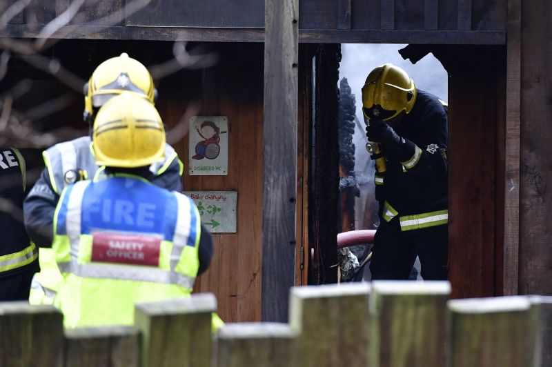 Firefighters work at the scene at Adventure cafe and shop near the Meerkat enclosure at London Zoo, London, Saturday, Dec. 23, 2017. London Zoo officials say a fire that broke out before the facility opened Saturday morning left one aardvark dead and four meerkats missing and presumed dead. Staff members were treated for smoke inhalation and shock after the blaze broke out near the zoo cafe in the early morning hours. (Dominic Lipinski/PA via AP)
