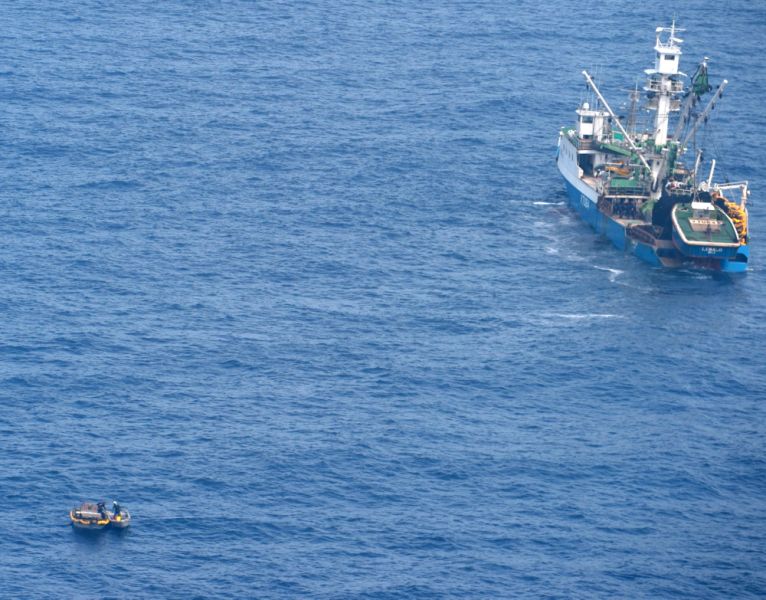 This photo released by the New Zealand Defence Force shows a wooden dinghy, left, carrying survivors from a missing ferry, and a fishing boat in the Pacific Ocean Sunday, Jan 28, 2018. Six adults and an unconscious baby were rescued Sunday from a life raft in the Pacific Ocean after drifting for four days in the blazing sun without water. The survivors had scrambled onto the small wooden dinghy after the ferry they were aboard sank, according to authorities. (New Zealand Defence Force via AP)