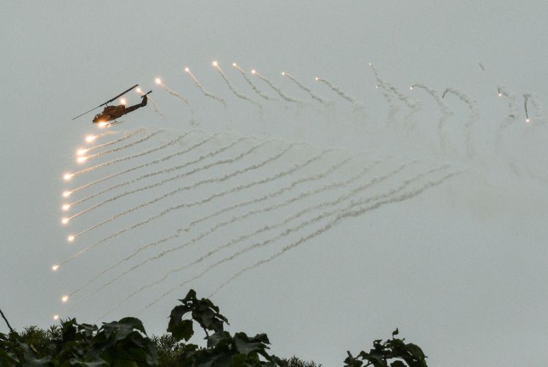A US-made AH-1W Super Cobra helicopter launches flares during the annual Taiwanese drill, which comes amid a new row with China over flight routes in the strait (AFP Photo/Mandy CHENG)