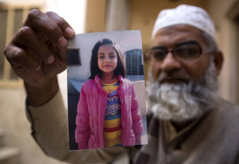 FILE - In this Thursday, Jan. 18, 2018, file photo, Mohammed Amin shows a picture of his seven year-old daughter, Zainab Ansari in Kasur, Pakistan. A public prosecutor in Pakistan says on Saturday, Feb. 17, 2018, a court has sentenced a serial killer to death after finding him guilty of killing eight children, including a 7-year-old girl whose rape and murder drew nationwide condemnation. (AP Photo/B.K. Bangash, File)