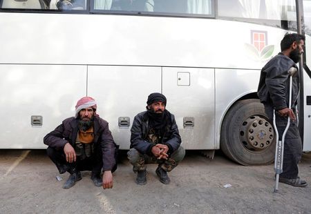 Rebel fighters are seen next to a bus before their evacuation, at Harasta highway outside Jobar, in Damascus, Syria March 26, 2018. REUTERS/Omar Sanadiki