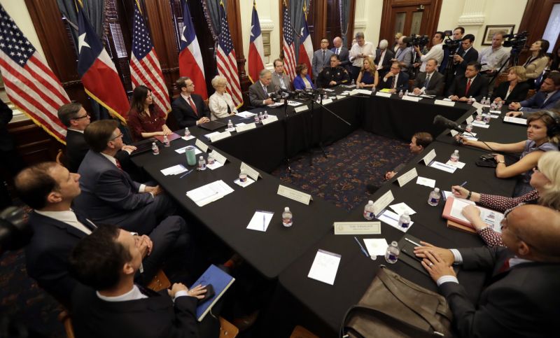 Texas Gov. Gregg Abbott, at microphones at center, hosts a roundtable discussion to address safety and security at Texas schools in the wake of the shooting at Santa Fe, at the State Capitol in Austin, Texas, Wednesday, May 23, 2018. Abbott, a Republican who has worked to expand gun rights in the state, called for the meetings as he weighs ideas for possible legislative action or executive orders. Two dozen groups were invited to attend the session, which was expected to include conversations on monitoring students' mental health. (AP Photo/Eric Gay)