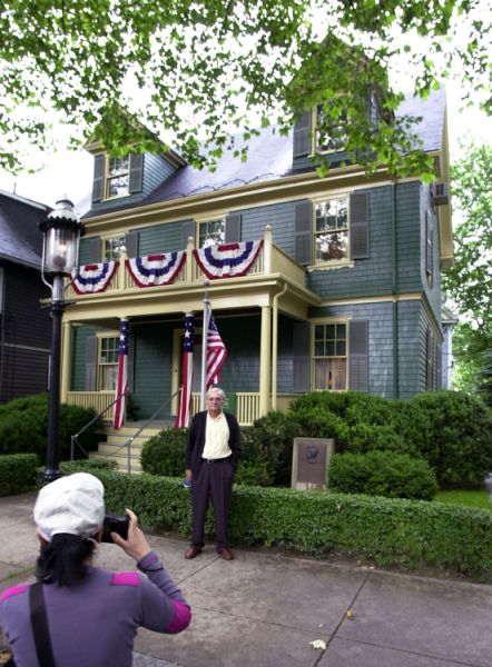 FILE--In this June 19, 2002 file photograph Leonor Suarez, of Brookline, Mass., left, takes a photograph of her brother, Joes Luis Suarez, of Almeria, Spain, in Brookline, in front of the family home of President John F. Kennedy and U.S. Sen. Robert F. Kennedy, D-NY. The suburban Boston house where Robert F. Kennedy was born, now a national historic site in tribute to his more famous brother, President John F. Kennedy, is holding a special exhibition to mark the 50th anniversary of RFK's assassination on June 6, 1968. (AP Photo/Steven Senne)