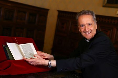Monsignor Cesare Pasini, chief of the Vatican Library, flips through a letter written by Christopher Columbus that had been stolen from its archives, returned by U.S. Homeland Security officials and American ambassador to the Vatican Library, at the Vatican June 14, 2018. REUTERS/Tony Gentile/Pool