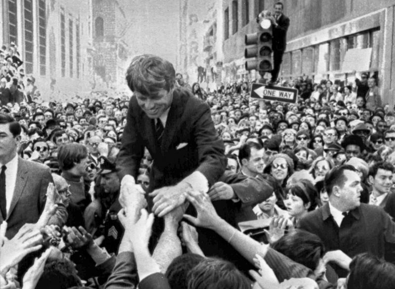 FILE - In this April 2, 1968 file photo U.S. Sen. Robert F. Kennedy, D-NY, shakes hands with people in a crowd while campaigning for the Democratic party's presidential nomination on a street corner, in Philadelphia. The suburban Boston house where Robert F. Kennedy was born, now a national historic site in tribute to his more famous brother, President John F. Kennedy, is holding a special exhibition to mark the 50th anniversary of RFK's assassination on June 6, 1968. (AP Photo/Warren Winterbottom, File)