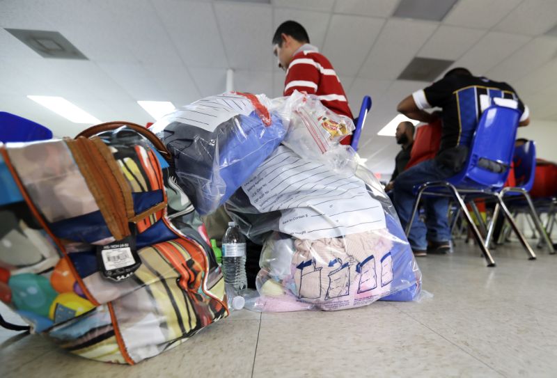 Immigrants belongings are piled on the floor inside the Catholic Charities of the Rio Grande Valley on Saturday, June 23, 2018, in McAllen, Texas. Families, who have been processed and released by U.S. Customs and Border Protection, wait inside the facility before continuing their journey to cities across the United States. (AP Photo/David J. Phillip)