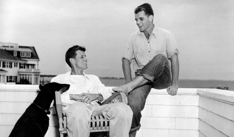 FILE--In this 1946 file photograph, John F. Kennedy, left, is shown with his brother, Robert Kennedy, and his dog, Mo, in Hyannisport, Mass. at the family's summer compound on Cape Cod. The suburban Boston house where Robert F. Kennedy was born, now a national historic site in tribute to his more famous brother, President John F. Kennedy, is holding a special exhibition to mark the 50th anniversary of RFK's assassination on June 6, 1968. (AP Photo)
