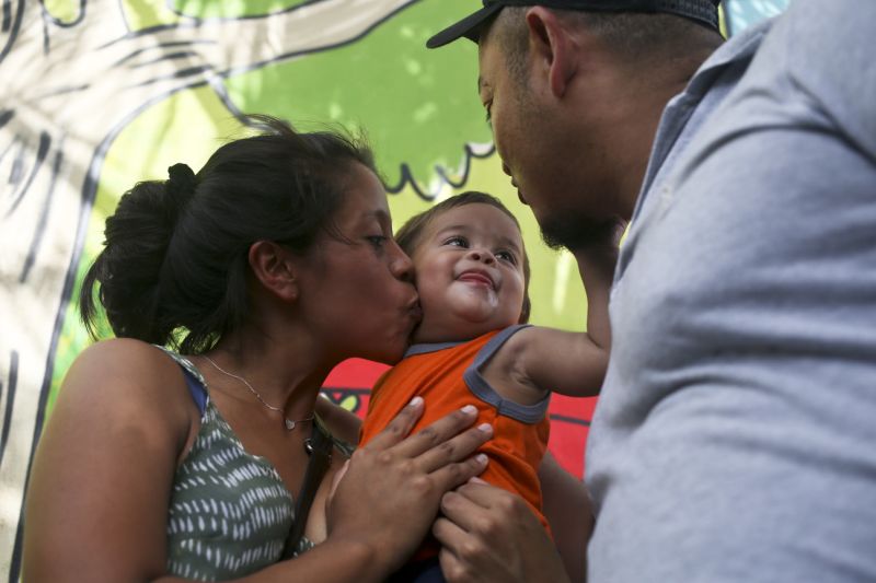Adalicia Montecino kisses her year-old son Johan Bueso Montecinos, who became a poster child for the U.S. policy of separating immigrants and their children, as Johan touches his father Rolando Bueso Castillo's face, in San Pedro Sula, Honduras, Friday, 20, 2018. Johan Bueso Montecinos arrived in San Pedro Sula and was reunited with his parents on a government bus. Captured by Border Patrol agents in March, Johan’s father was deported and the then 10-month-old remained at an Arizona shelter. (AP Photo/Esteban Felix)