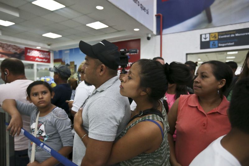 Rolando Bueso Castillo and his wife Adalicia Montecinos wait for the arrival of their year-old son who became a poster child for the U.S. policy of separating immigrants and their children, at the airport in San Pedro de Sula, Honduras, Friday, 20, 2018. Johan Bueso Montecinos arrived in San Pedro Sula and was reunited with his parents on a government bus. Captured by Border Patrol agents in March, Johan’s father was deported — and the then 10-month-old remained at an Arizona shelter. (AP Photo/Esteban Felix)