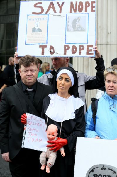 Protestors against clerical abuse and the visit of Pope Francis gather at the General Post Office (GPO) in Dublin, calling for gay and trans gender recognition by the Catholic Church among other demands. (AFP Photo/Paul FAITH)