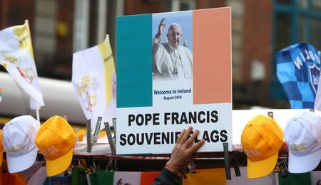 A man sells Pope Francis souvenirs from a stall in Dublin, Ireland August 24, 2018.  REUTERS/Hannah McKay