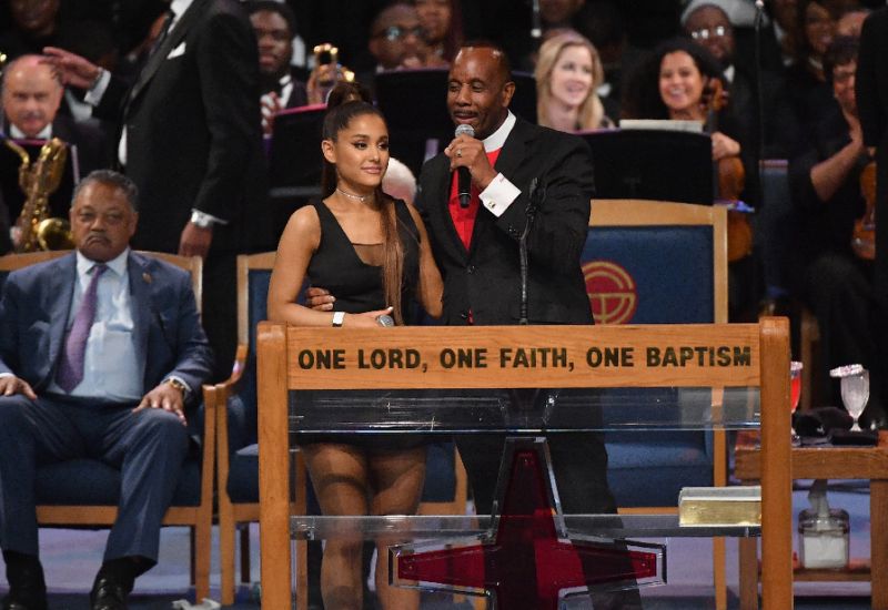 After her performance, Ariana Grande was congratulated by Bishop Charles H. Ellis III, who placed his arm high above her waist with his fingers pressed against her chest (AFP Photo/Angela Weiss)
