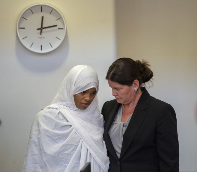 Hujrah Wahhaj, left, talks with her attorney Marie Legrand Miller during a hearing on a motion to dismiss in the Taos County Courthouse, Wednesday, Aug. 29, 2018, in Taos, N.M. Judge Emilio Chavez ordered charges against her and two other defendants dropped as the result of a deadline missed by prosecutors. (Eddie Moore/The Albuquerque Journal via AP, Pool)