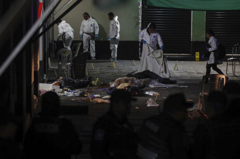 Forensic investigators examine the crime scene where authorities say at least four people have been killed and nine wounded in a shooting at Garibaldi Plaza, in Mexico City, Friday, Sept. 14, 2018. Gunmen dressed as mariachis opened fired on an establishment in the capital’s emblematic plaza, a spot popular for tourists. (AP Photo/Stringer)