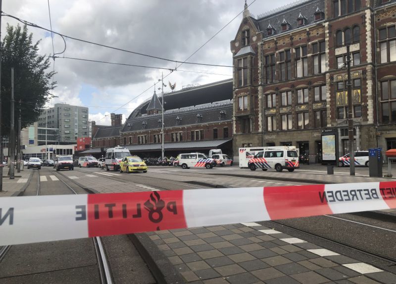 Dutch police officers near the scene of a stabbing attack near the central daily station in Amsterdam, the Netherlands, Friday Aug. 31, 2018. Police the Dutch capital shot and wounded a suspect Friday following a stabbing at the central railway station. Amsterdam police said in a series of tweets that two people were injured in the stabbing and the suspect was then shot by officers. (AP Photo/Alex Furtula)