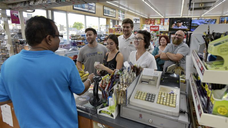 People line up at the Kwik Stop food store at 46th Avenue and Hollywood Boulevard, in Hollywood, Fla., to buy Mega Millions lottery tickets, Friday, Oct. 19, 2018. (Michael Laughlin/South Florida Sun-Sentinel via AP)
