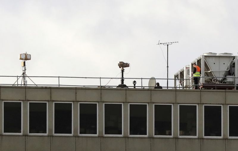 Counter drone equipment deployed on a rooftop at Gatwick airport as the airport and airlines work to clear the backlog of flights delayed by a drone incident earlier in the week, in Crawley, England, Saturday, Dec. 22, 2018. London's Gatwick Airport took strides toward running a full schedule Saturday as police questioned a man and a woman in connection with the drone intrusions that caused mayhem for tens of thousands of holiday travelers. (Gareth Fuller/PA via AP)