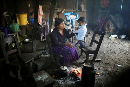Catarina Alonzo, mother of Felipe Gomez Alonzo, a 8-year-old boy detained alongside his father for illegally entering the U.S., who fell ill and died in the custody of U.S. Customs and Border Protection (CBP), is seen at her home with her son Oliver in the village of Yalambojoch, Guatemala December 27, 2018. REUTERS/Luis Echeverria