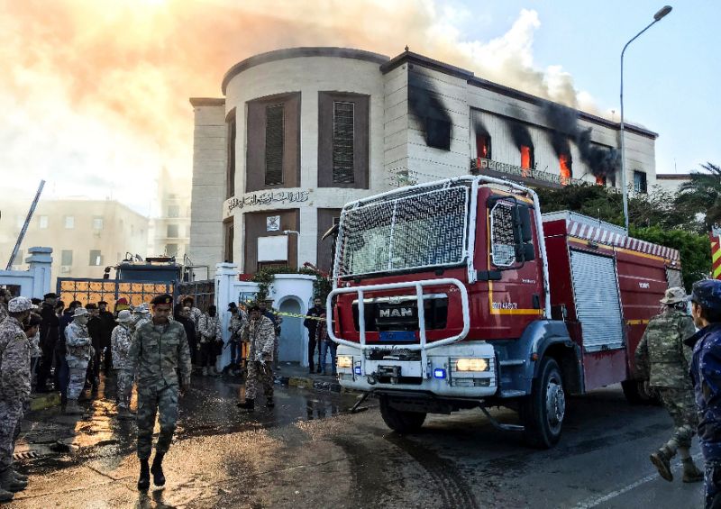 A fire truck and security officers outside Libya's foreign ministry in the capital Tripoli on December 25, after an attack that was claimed by Islamic State (AFP Photo/Mahmud TURKIA)