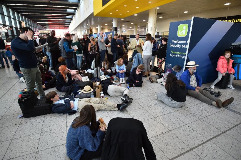 Passengers wait at the North Terminal at London Gatwick Airport,as police frantically searched for the operators of the drones that had forced the suspension of all flights (AFP Photo/Glyn KIRK                  )