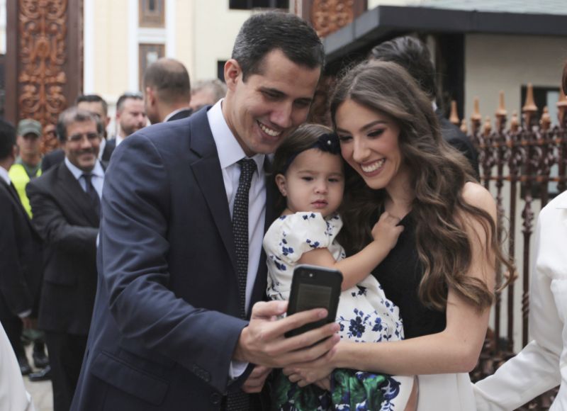 Incoming parliamentary president Juan Guaido, left, takes a selfie photo with his wife Fabiana Rosales and his daughter Miranda Guaido upon his arrival to swears in the new board of the National Assembly in Caracas, Venezuela, Saturday, Jan. 5, 2019. Venezuela's opposition-controlled congress holds its first session of the year under new leadership of Juan Guaido that is promising a more frontal assault on President Nicolas Maduro as he prepares to start a second term widely condemned as illegitimate. (AP Photo/Fernando Llano)