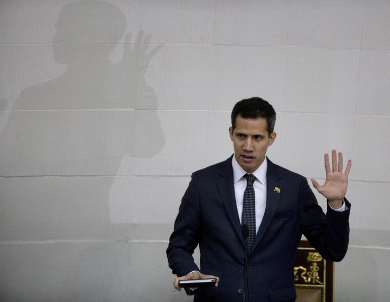 Venezuelan lawmaker Juan Guaido swears in as President of the National Assembly in Caracas, Venezuela, Saturday, Jan. 5, 2019. Venezuela's opposition-controlled congress holds its first session of the year under new leadership of Juan Guaido that is promising a more frontal assault on President Nicolas Maduro as he prepares to start a second term widely condemned as illegitimate. (AP Photo/Fernando Llano)