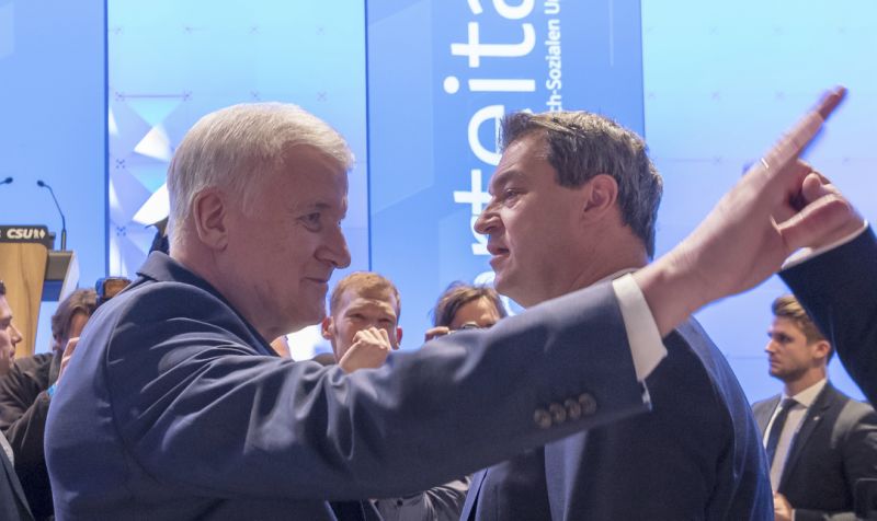 New head of the Christian Social Union CSU Markus Soeder, right, speaks to his predecessor Horst Seehofer at a party meeting in Munich, Germany, Saturady, Jan. 19, 2019. (Peter Kneffel/dpa via AP)