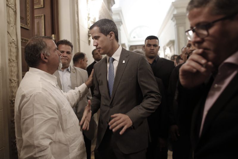 Venezuela' self proclaimed interim president Juan Guaido speaks to a supporter as he arrives at the National Assembly, in Caracas, Venezuela, Wednesday, Feb. 13, 2019. Guaido said Wednesday that the National Assembly has appointed six executives to a transitional board for its PDVSA state-owned oil company and its U.S. subsidiaries, including Houston-based refiner Citgo. (AP Photo/Ariana Cubillos)