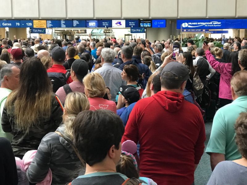 People wait to get through security at the Orlando International Airport following a security incident on Saturday, Feb. 2, 2019. Passengers on shuttles to gates at Florida's busiest airport had to be brought back for a second screening, bringing security checkpoints to a temporary standstill. A spokeswoman for Orlando International Airport told television station WKMG on Saturday that the passengers were returned in 