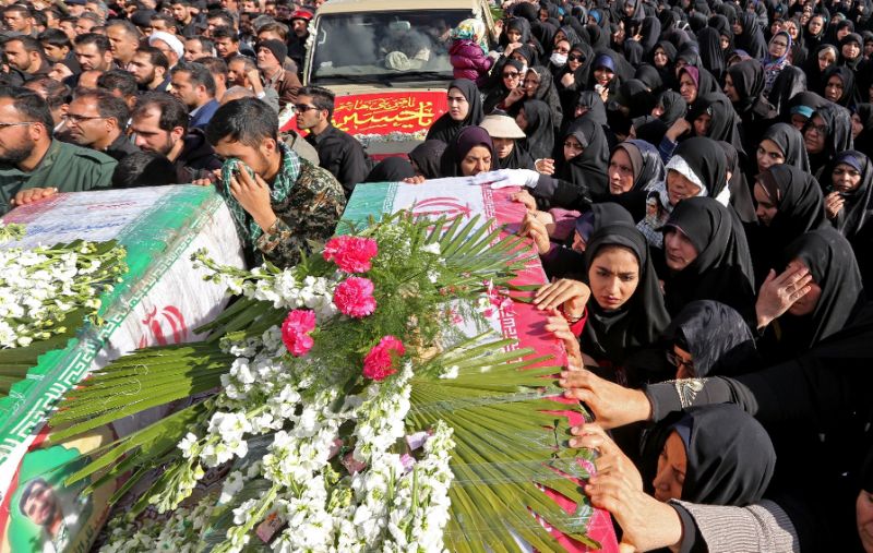 Iranian mourners gather around the coffins of Revolutionary Guards who were killed in a suicide bomb attack at their funeral in the central city of Isfahan on February 16, 2019