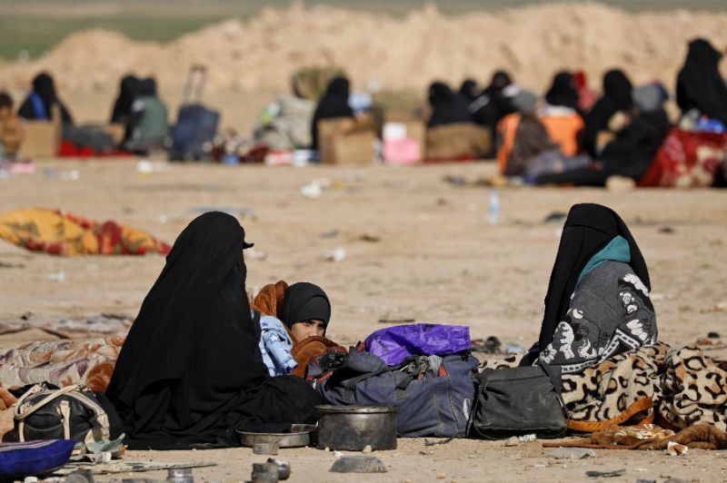 Civilians fleeing the last Islamic State group enclave have to camp out in the open while waiting for the US-backed Syrian Democratic Forces to screen and register them before taking them to a camp for the displaced (AFP Photo/Delil SOULEIMAN)