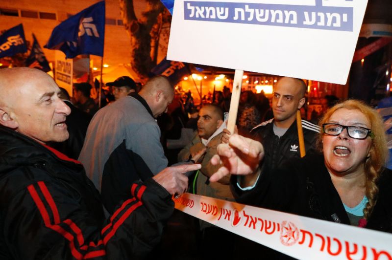 Supporters and opponents of Israeli Prime Minister Benjamin Netanyahu held rival rallies in Tel Aviv after the attorney general said he intended to file graft charges against the premier (AFP Photo/JACK GUEZ)