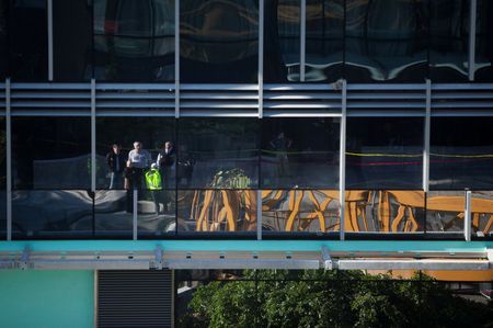 Seattle emergency personnel are reflected in the Google office building that part of a construction crane fell from, on Mercer Street in Seattle, Washington, U.S. April 27, 2019.  REUTERS/Lindsey Wasson