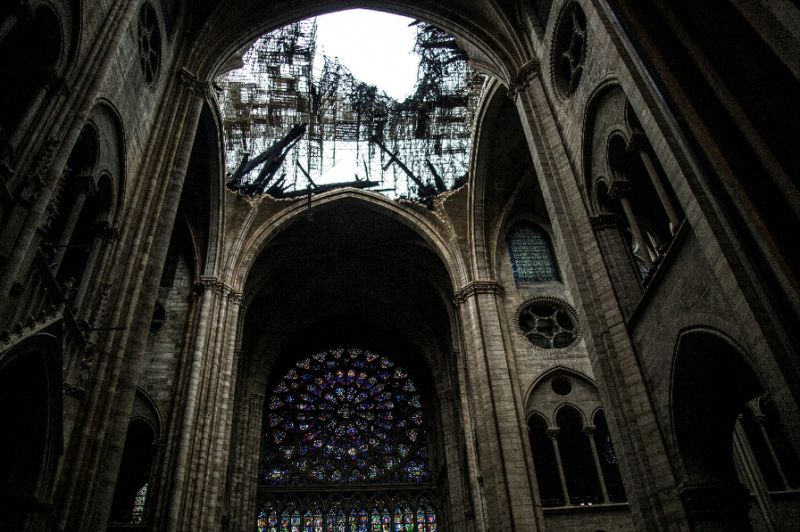 One of the rose windows below the damaged roof of Notre-Dame (AFP Photo/Amaury BLIN)