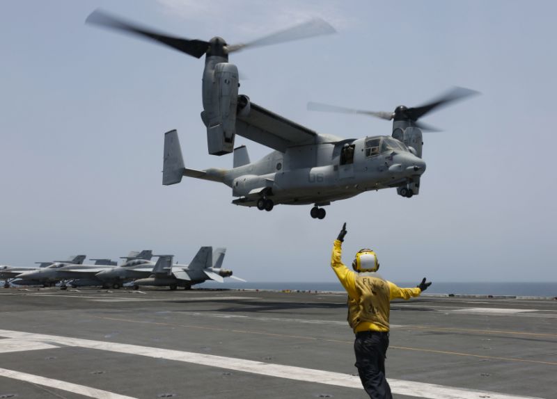 In this Friday, May 17, 2019, photo released by the U.S. Navy, Aviation Boatswain's Mate 2nd Class Nicholas Hawkins, from Houston, Texas, signals an MV-22 Osprey to land on the flight deck of the Nimitz-class aircraft carrier USS Abraham Lincoln in the Arabian Sea. Commercial airliners flying over the Persian Gulf risk being targeted by 