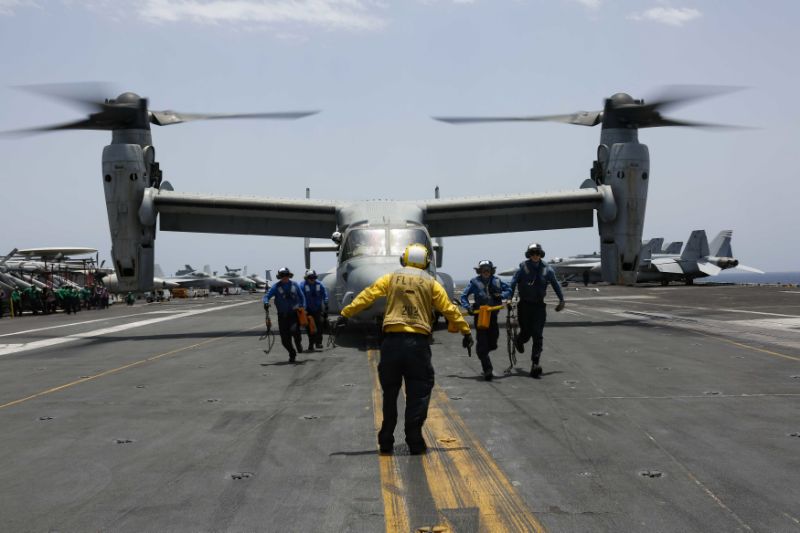 CORRECTS DATE - In this Friday, May 17, 2019, photo, released by the U.S. Navy, sailors work around an MV-22 Osprey as it lands on the flight deck of the Nimitz-class aircraft carrier USS Abraham Lincoln in the Arabian Sea. Commercial airliners flying over the Persian Gulf risk being targeted by 