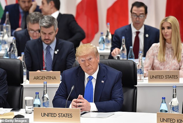 Donald Trump (front C) attends the session 3 on women's workforce participation where daughter Ivanka Trump made a presentation