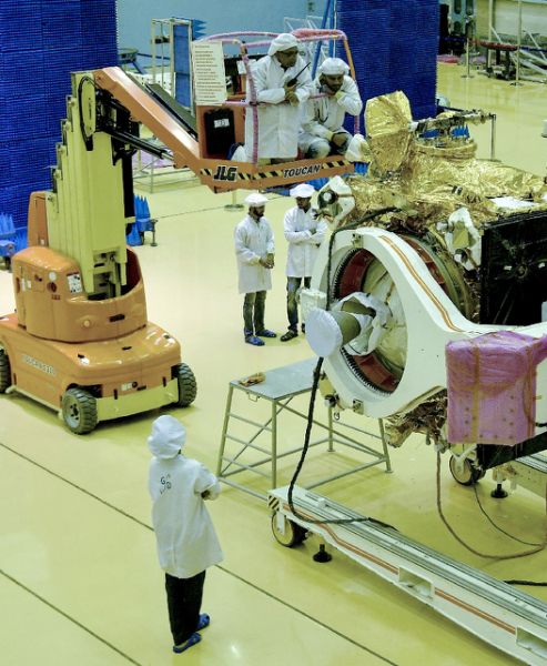 Scientists work on the orbiter vehicle of India's first moon lander (AFP Photo/MANJUNATH KIRAN)
