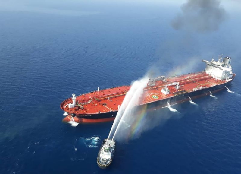An Iranian navy boat trying to control fire from Norwegian owned Front Altair tanker said to have been attacked in the waters of the Gulf of Oman (AFP Photo/-)