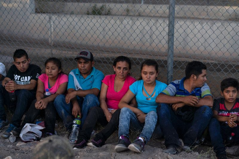 Migrants, mostly from Central America, wait in El Paso, Texas to board a van which will take them to a US Border Patrol processing center (AFP Photo/Paul Ratje)