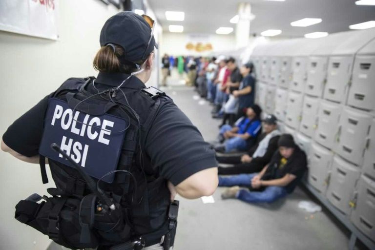 A Homeland Security officer guards some of the 680 suspected undocumented migrants detained in Mississippi after Immigration and Customs Enforcement officers raided several slaughterhouses (AFP Photo/HO)