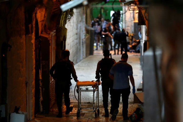 Israeli security forces gather at the site of a reported stabbing attack at one of the entrances of Al-Aqsa Mosque compound in the Old City of annexed east Jerusalem